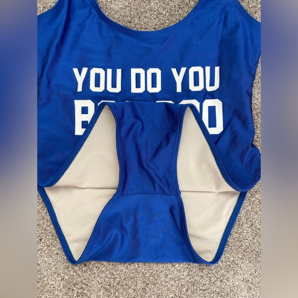 Blue one piece swimsuit with saying, “you do you boo boo,” in white letters. - Picture 3 of 5